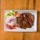 Beef katsu renyah dengan saus tonkatsu, dipotong tipis, disajikan di piring putih.
